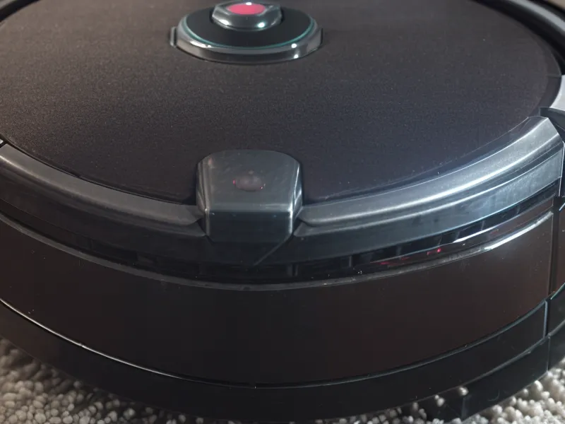 Close-up of cleaning infrared cliff sensors on the bottom of a robot vacuum.